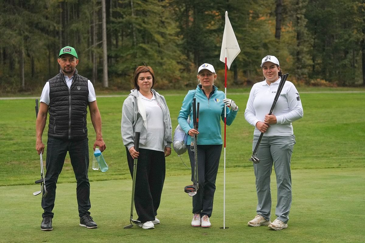 Four players on a green at Golf Brdo, beside the flag