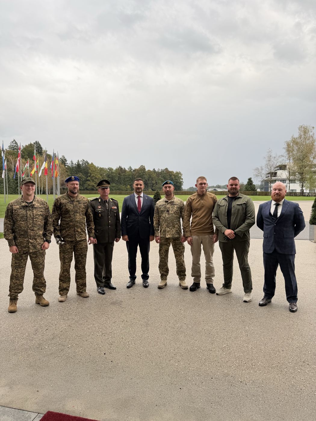The Ukrainian delegation lined up at Brdo, Slovenia, in front of the flags